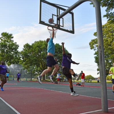 Person jumping to shoot the ball during a Volo basketball game.