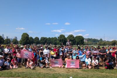Hundreds of happy folks gather with pokemon go signage