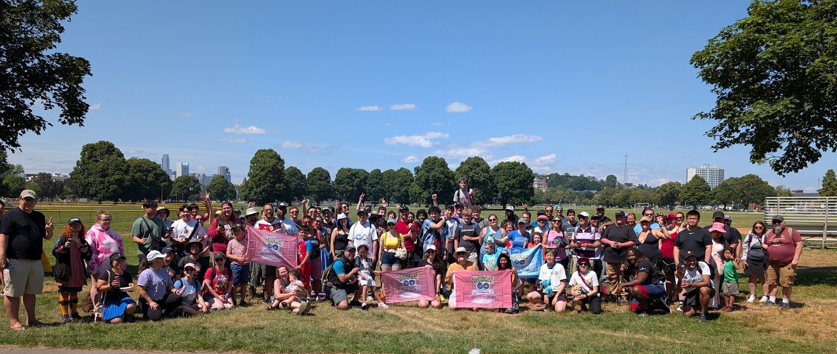 Hundreds of happy folks gather with pokemon go signage